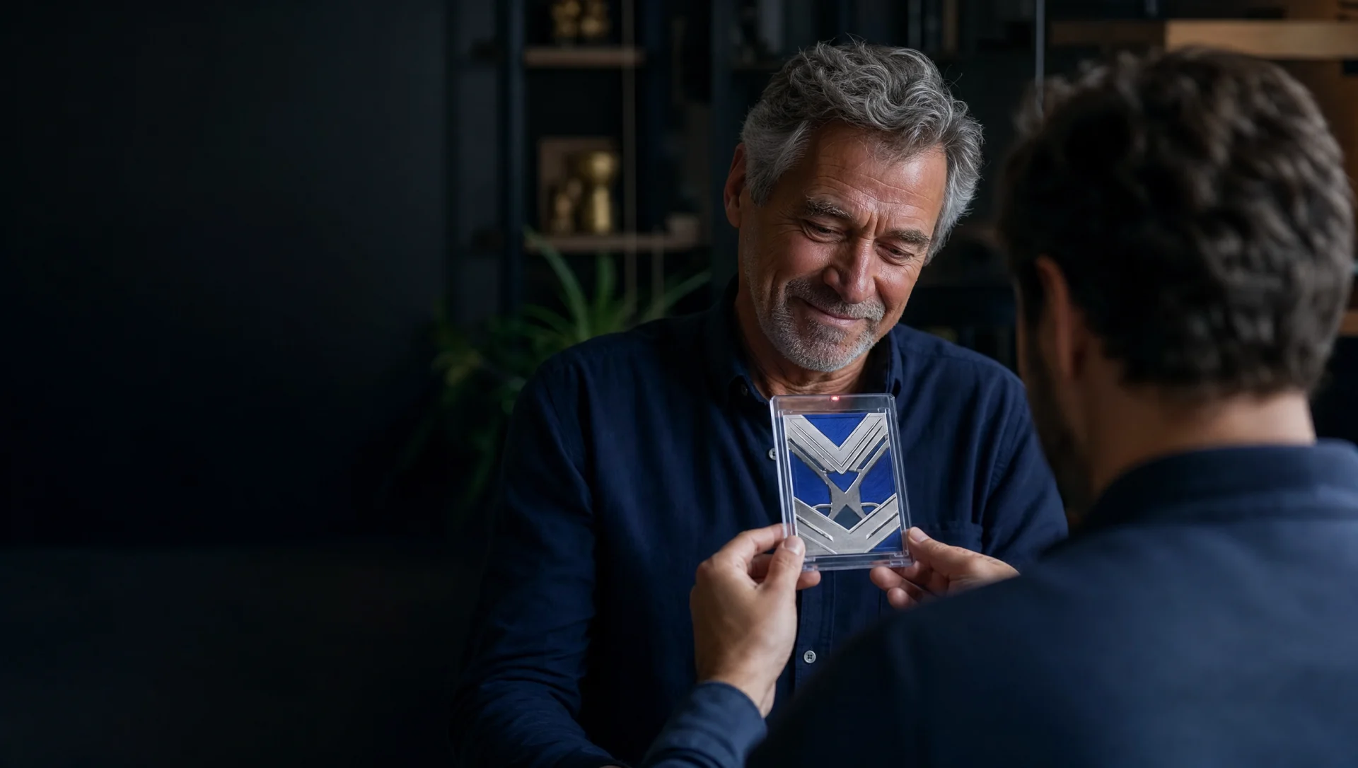 An adult child presenting a protected collectible card to their father